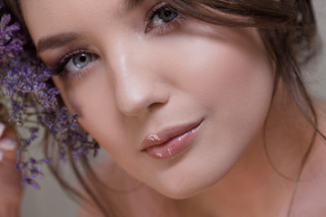 Cute young woman portrait close-up, fresh spring image with flowers. Beautiful girl