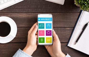 Woman holding smartphone with digital wallet application