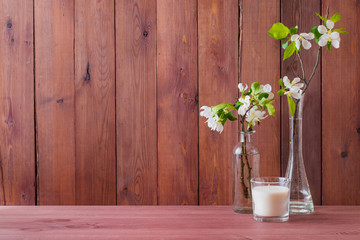 Home interior with decor elements. White spring flowers in a vase on a wooden table