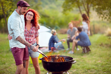 Love couple prepare fire on grill