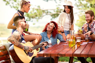 Cheerful curly ginger girl toasts with friends