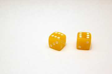 Dices made of light amber on white background isolated