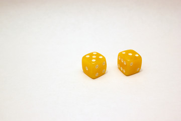 Dices made of light amber on white background isolated