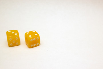 Dices made of light amber on white background isolated