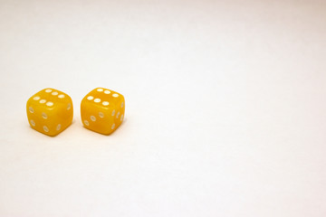 Dices made of light amber on white background isolated