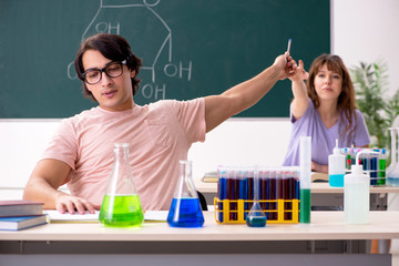 Two chemists students in classroom