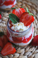 Close-up of homemade strawberry cheesecake in a jar