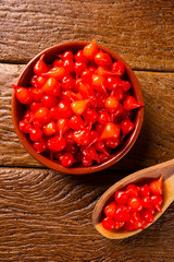 Biquinho Pepper into a spoon. Capsicum Chinense over table