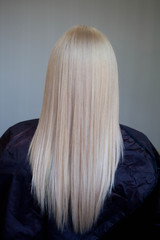 Naklejka premium The dyed and cut hair of white color on a gray background