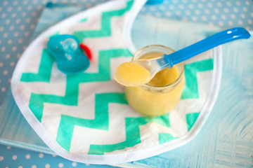 baby mashed with spoon in glass jar