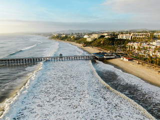 Fototapeta na wymiar Aerial view of San Clemente Pier with beach and coastline. San Clemente city in Orange County, California, USA. Travel destination in the South West Coast. Famous beach for surfer.