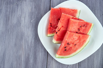 Chopped pieces of watermelon on a white plate