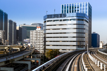 Obraz na płótnie Canvas View of modern skyscrapers, highway and Yurikamome rail track in Tokyo, Japan. 
