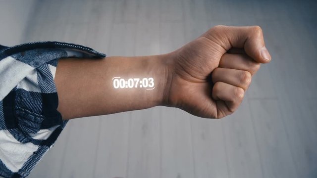 Close-up Man starting up a Hologram Futuristic Stopwatch on his hand