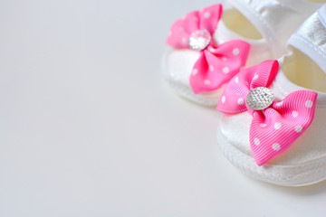 Baby girl booties with pink bow, copy space