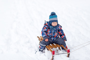 Fototapeta na wymiar Kid enjoy at sledge