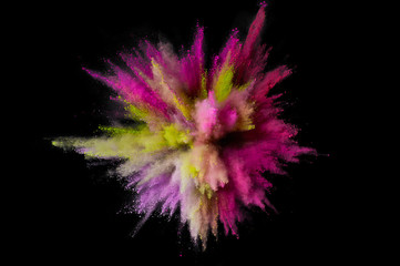 Colored powder explosion. Abstract closeup dust on backdrop. Colorful explode. Paint holi