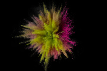 Colored powder explosion. Abstract closeup dust on backdrop. Colorful explode. Paint holi