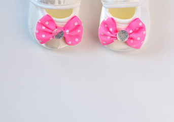 Baby girl glamour booties with pink bow, copy space