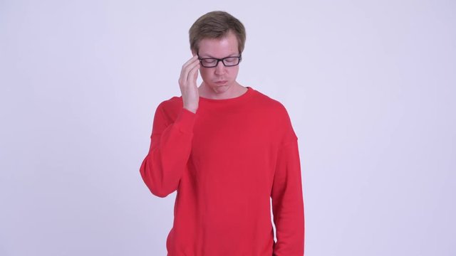 Serious young man thinking and looking down