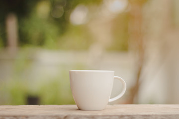 Cup of hot coffee in the morning green bokeh background.copy space.