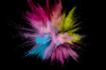 Colored powder explosion. Abstract closeup dust on backdrop. Colorful explode. Paint holi