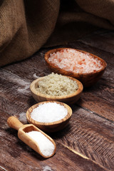 Fototapeta na wymiar sea salt in bowl. Crystals of salt on table and himalayan salt.