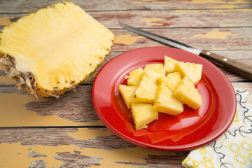 Freshly sliced pineapple on a rustic table