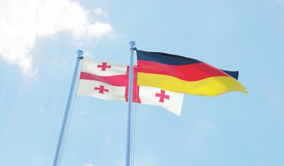 Georgia and Germany, two flags waving against blue sky. 3d image
