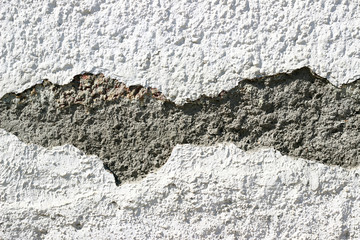 Deteriorating white wall with cement mortar surface texture surface detail close up