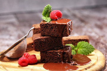 chocolate brownie cake dessert with raspberry and spices on a rustic background