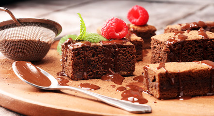chocolate brownie cake dessert with raspberry and spices on a rustic background