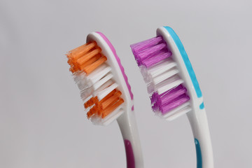 Toothbrushes and toothpaste on a mirror shelf. Oral hygiene products.