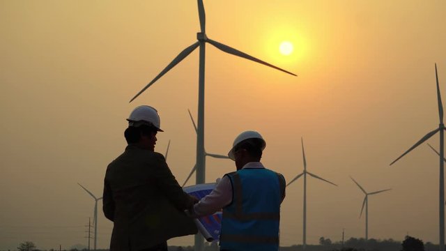 The two Asian engineers are checking the system for wind turbines footage 4K