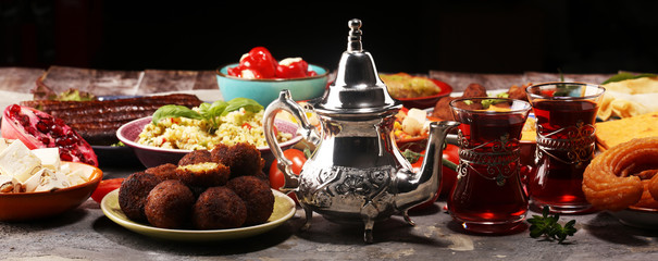 Middle eastern or arabic dishes and assorted meze, concrete rustic background. Falafel. Turkish Dessert Baklava with pistachio. Halal food. Lebanese cuisine