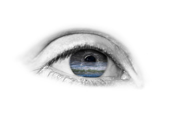 sea and the waves in the beautiful blue eyes of a young girl reflected