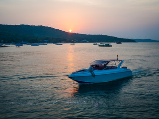 Naklejka premium White motor boat at Sunset on Thailand sea