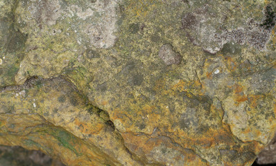 Multicolor Rock texture and surface background. Cracked and weathered natural stone background.