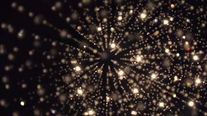 Bottom-up view bokeh shift focus colorful lights effect, pan slow motion shot of a beautiful crystal chandelier in a dark background. - Powered by Adobe