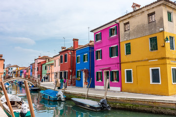 Naklejka na ściany i meble Italy, Venice, Burano, canals and boats among the typical colored houses.