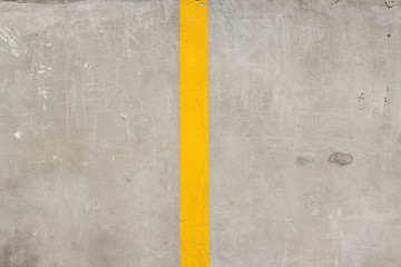 Concrete mortar cement wall with middle yellow line surface texture