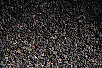 Stone wall of natural daek stones, copy space