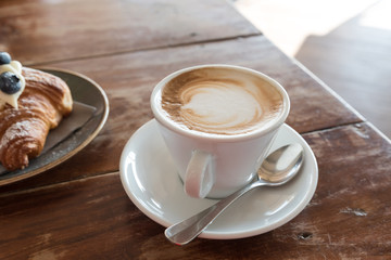 Croissant and cappuccino for breakfast