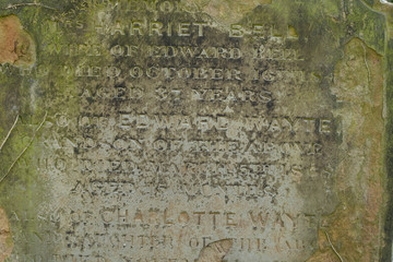 An Old Gravestone surface with text letters on it, close up