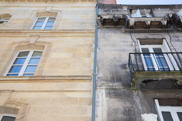 before and after between a wash cleaned house facade and a dirty one in a city center