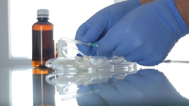 Slow Motion with Doctor Hands Protected with Gloves Checking Perfusion Needle