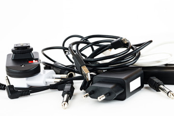 Different wires and connectors on a white background, equipment mess