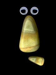 Figures laid out by children from multi-colored pebbles. Figure from multi-colored stones. Stone figures.