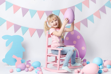 Fototapeta na wymiar Cute girl with Easter eggs on white background. Girl play with eggs. Easter colored eggs