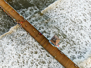 Aerial view of San Clemente Pier with lifeguard tower for surfer. San Clemente city in Orange County, California, USA. Travel destination in the South West Coast. Famous beach for surfer. 